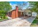 Charming brick home with a covered carport and well-manicured lawn at 218 N Bost St, Statesville, NC 28677