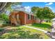 Charming brick home with a welcoming porch and mature landscaping with a walkway leading to the entrance at 218 N Bost St, Statesville, NC 28677