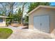 Detached garage with white doors and a paved patio at 218 N Bost St, Statesville, NC 28677