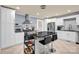 Modern kitchen featuring white cabinetry, a stainless steel range hood, and a center island with seating at 218 N Bost St, Statesville, NC 28677