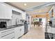 Well-lit kitchen with tile backsplash, stainless appliances and eat in dining area at 218 N Bost St, Statesville, NC 28677