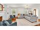 Bright living room with large windows, plush seating, and an inviting atmosphere, perfect for relaxing and entertaining at 218 N Bost St, Statesville, NC 28677