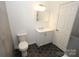 Renovated bathroom featuring new sink, vanity, toilet, and modern fixtures at 306 E Burnsville St, Wadesboro, NC 28170