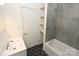 Updated bathroom with modern gray tile, tub, and new vanity sink at 306 E Burnsville St, Wadesboro, NC 28170
