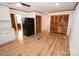 Kitchen area with wood floors, stainless steel fridge and white cabinets at 306 E Burnsville St, Wadesboro, NC 28170