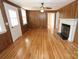 Living room with wood paneling, fireplace and wood floors at 306 E Burnsville St, Wadesboro, NC 28170