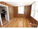 Inviting living room with wood paneling, and gleaming hardwood floors at 306 E Burnsville St, Wadesboro, NC 28170