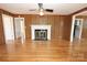 Inviting living room with hardwood floors, a ceiling fan, a classic fireplace, and wood trim at 306 E Burnsville St, Wadesboro, NC 28170