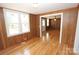Inviting living room with wood paneling, and gleaming hardwood floors at 306 E Burnsville St, Wadesboro, NC 28170