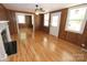 Inviting living room with wood paneling, fireplace and gleaming hardwood floors at 306 E Burnsville St, Wadesboro, NC 28170