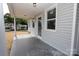 Inviting porch with light siding, ceiling lights, and a view of the neighborhood at 306 E Burnsville St, Wadesboro, NC 28170