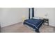 Bedroom features a cozy bed with blue coverlet, ample natural light, and comfortable furniture at 4406 Huntley Glen Dr, Pineville, NC 28134