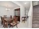 Elegant dining room with a wooden table, chandelier, and a classic china cabinet at 4406 Huntley Glen Dr, Pineville, NC 28134
