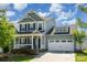 Charming two-story home with a welcoming front porch and a spacious two-car garage at 4406 Huntley Glen Dr, Pineville, NC 28134