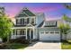 Charming two-story home with a welcoming front porch and a spacious two-car garage at 4406 Huntley Glen Dr, Pineville, NC 28134