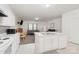 Bright kitchen view with island, white cabinets, and open access to the living room at 4406 Huntley Glen Dr, Pineville, NC 28134