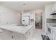 Bright kitchen with an island, white cabinets, and modern appliances at 4406 Huntley Glen Dr, Pineville, NC 28134