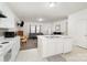 Bright kitchen view with island, white cabinets, and open access to the living room at 4406 Huntley Glen Dr, Pineville, NC 28134