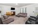 Spacious living room with sofas, a TV, and a table with chairs at 4406 Huntley Glen Dr, Pineville, NC 28134