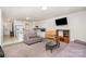 Inviting living room and kitchen area with sofas, a TV, and an island at 4406 Huntley Glen Dr, Pineville, NC 28134