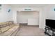 Relaxing living room space with a comfortable sofa, TV setup, and serene atmosphere at 4406 Huntley Glen Dr, Pineville, NC 28134