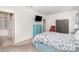 Comfortable bedroom featuring light walls, floral bedspread, and modern entertainment with mounted TV at 4406 Huntley Glen Dr, Pineville, NC 28134