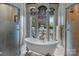 Freestanding tub next to large windows providing abundant natural light and outdoor views at 4465 3Rd Nw St, Hickory, NC 28601