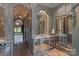 Luxurious bathroom with terracotta tile floor, ornate mirrors, and arched doorway at 4465 3Rd Nw St, Hickory, NC 28601