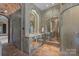 Elegant bathroom boasting detailed vanity, large mirror, and terracotta tile flooring at 4465 3Rd Nw St, Hickory, NC 28601