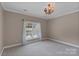 Neutral bedroom featuring carpet, classic light fixture, and a window providing lots of natural light at 4465 3Rd Nw St, Hickory, NC 28601