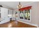 Bright breakfast nook with hardwood floors, built-in desk, large windows and antique chandelier at 4465 3Rd Nw St, Hickory, NC 28601