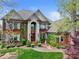 Stately red brick home with lush landscaping, a fountain, and charming architectural details at 4465 3Rd Nw St, Hickory, NC 28601