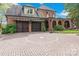 A two-story red brick home featuring a circle driveway, multiple dormers, and an attached two-car garage at 4465 3Rd Nw St, Hickory, NC 28601