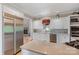 Well-lit kitchen featuring white cabinetry, stainless steel appliances, and view into fireplace at 4465 3Rd Nw St, Hickory, NC 28601