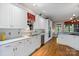 Modern white kitchen with stainless steel appliances, ample counter space, and wooden floors at 4465 3Rd Nw St, Hickory, NC 28601