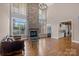 Living room featuring a stone fireplace, hardwood floors, and bright windows at 4465 3Rd Nw St, Hickory, NC 28601