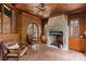 Cozy living room with brick walls, wood ceiling, tile floors, stone fireplace and comfortable seating at 4465 3Rd Nw St, Hickory, NC 28601