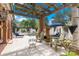 Inviting outdoor patio with pergola, stone columns, fireplace, comfortable seating and lush landscaping at 4465 3Rd Nw St, Hickory, NC 28601