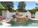 Stunning swimming pool with stone accents, fountain, tile surround, and well-manicured landscaping at 4465 3Rd Nw St, Hickory, NC 28601