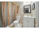 Bathroom with a tiled shower, vanity and decorative mirror at 4561 Walden Pond Trwy, Concord, NC 28025