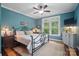 Bedroom featuring a wrought iron bed frame, a ceiling fan, and a large window at 4561 Walden Pond Trwy, Concord, NC 28025