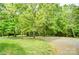 Gravel driveway winding through lush green trees leading to a private residence at 4561 Walden Pond Trwy, Concord, NC 28025
