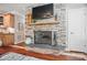 Living room stone fireplace with mounted tv and hardwood flooring at 4561 Walden Pond Trwy, Concord, NC 28025