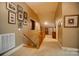 Hallway features artwork, carpet flooring and opens up to what could be a possible extra room at 4561 Walden Pond Trwy, Concord, NC 28025