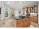 Kitchen features an island cooktop, stainless refrigerator, tile backsplash, and ample cabinet space at 4561 Walden Pond Trwy, Concord, NC 28025