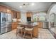 Spacious kitchen with wood cabinets, stainless steel appliances and large island with stool seating at 4561 Walden Pond Trwy, Concord, NC 28025