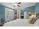 Inviting main bedroom with a ceiling fan, outside access, and tranquil blue walls at 4561 Walden Pond Trwy, Concord, NC 28025
