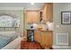 Convenient wet bar featuring custom cabinetry, granite countertop, and a wine cooler at 4561 Walden Pond Trwy, Concord, NC 28025
