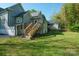 View of a backyard, with a wooden deck and stairs at 600 3Rd St, Spencer, NC 28159