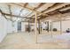Spacious unfinished basement with exposed beams and a brick chimney at 600 3Rd St, Spencer, NC 28159